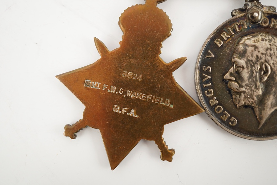 A medal group comprising of a Meritorious Service medal, a 1939 to 1945 Defence Medal, and a First World War trio awarded to 3824 SJT. F.W.G. Wakefield. R.F.A., together with a Delhi Durbar Medal 1911, crudely engraved t